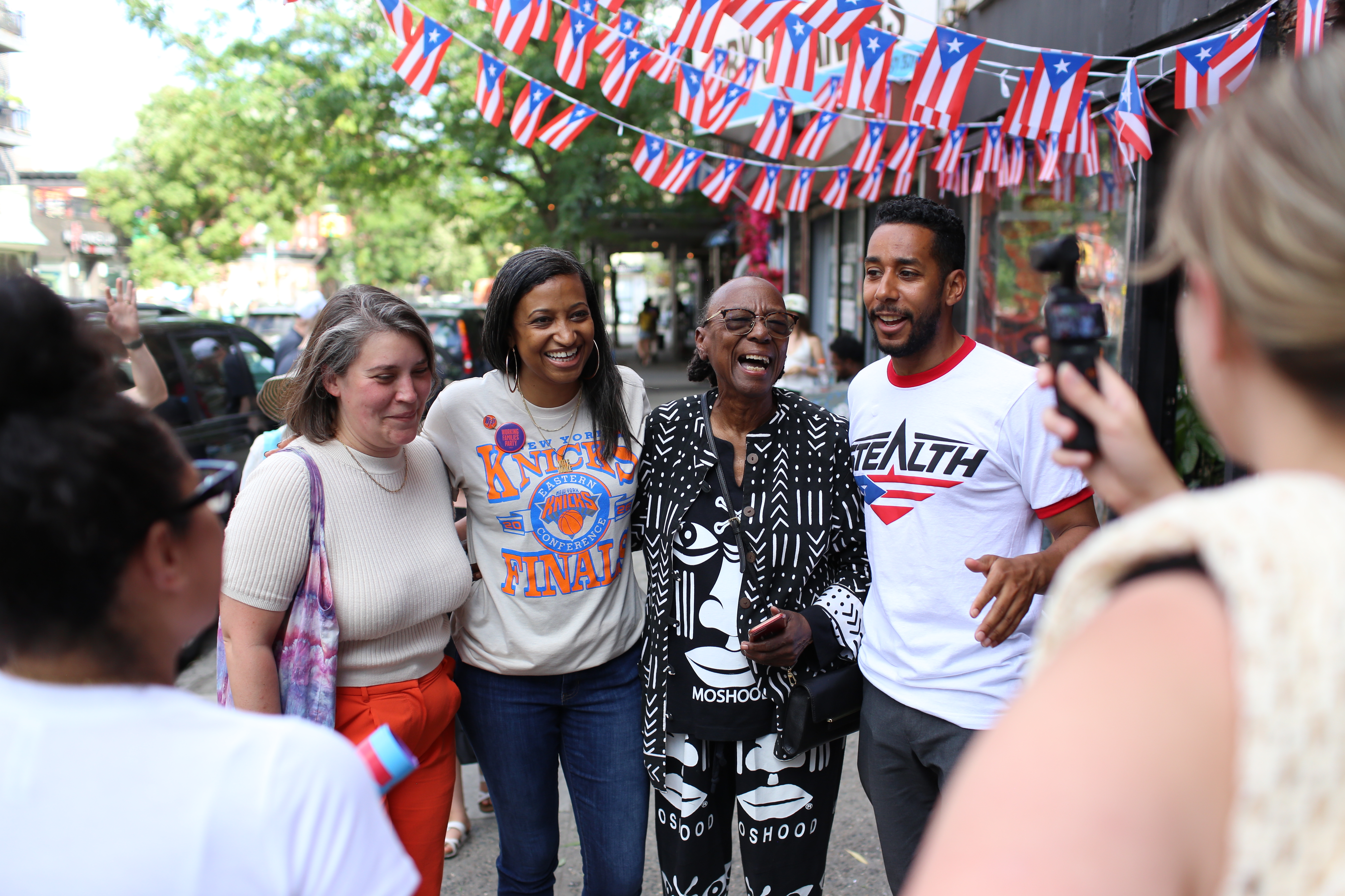 Jose Alvarado, Antonio Reynoso and Nydia Velazquez celebrate the Knicks championship at Toñita's Caribbean Social Club