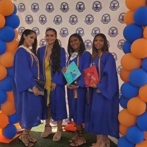 Graduation photo with four young women, including Michelle Tejada, surrounded by balloons. 